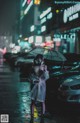 A woman in a gas mask holding an umbrella in the rain.